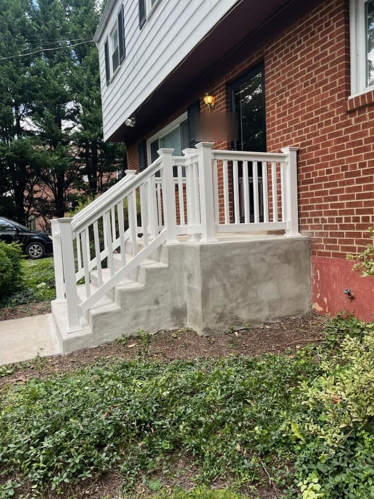 After: the finished white rail on the steps and stoop, from the side